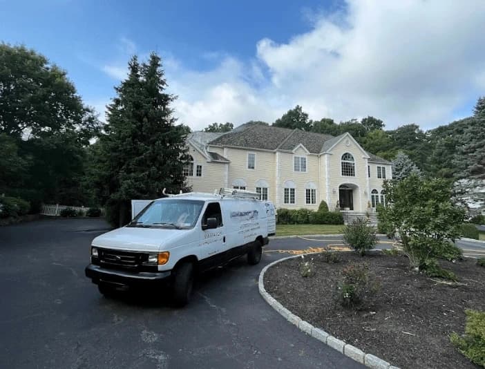 Willoughby Power Washing technician performing thorough gutter cleaning service in Willoughby